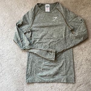 Gymshark long sleeved compression top in army green blend with finger holes.